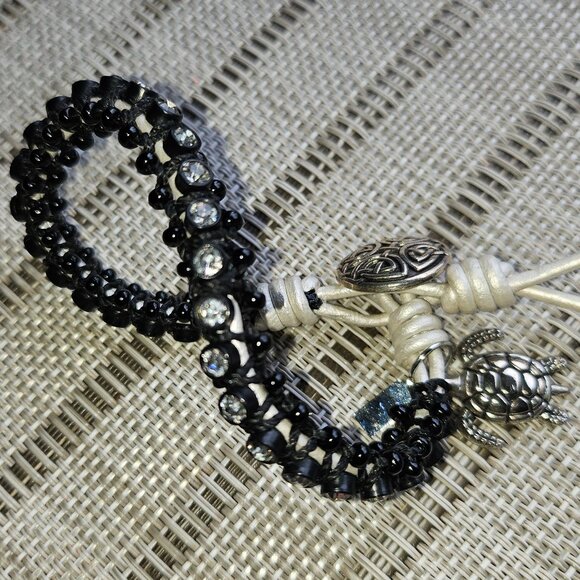 Bracelet with Rhinestones Set in Black Beads with White Tie and Turtle Charm - Picture 2 of 9